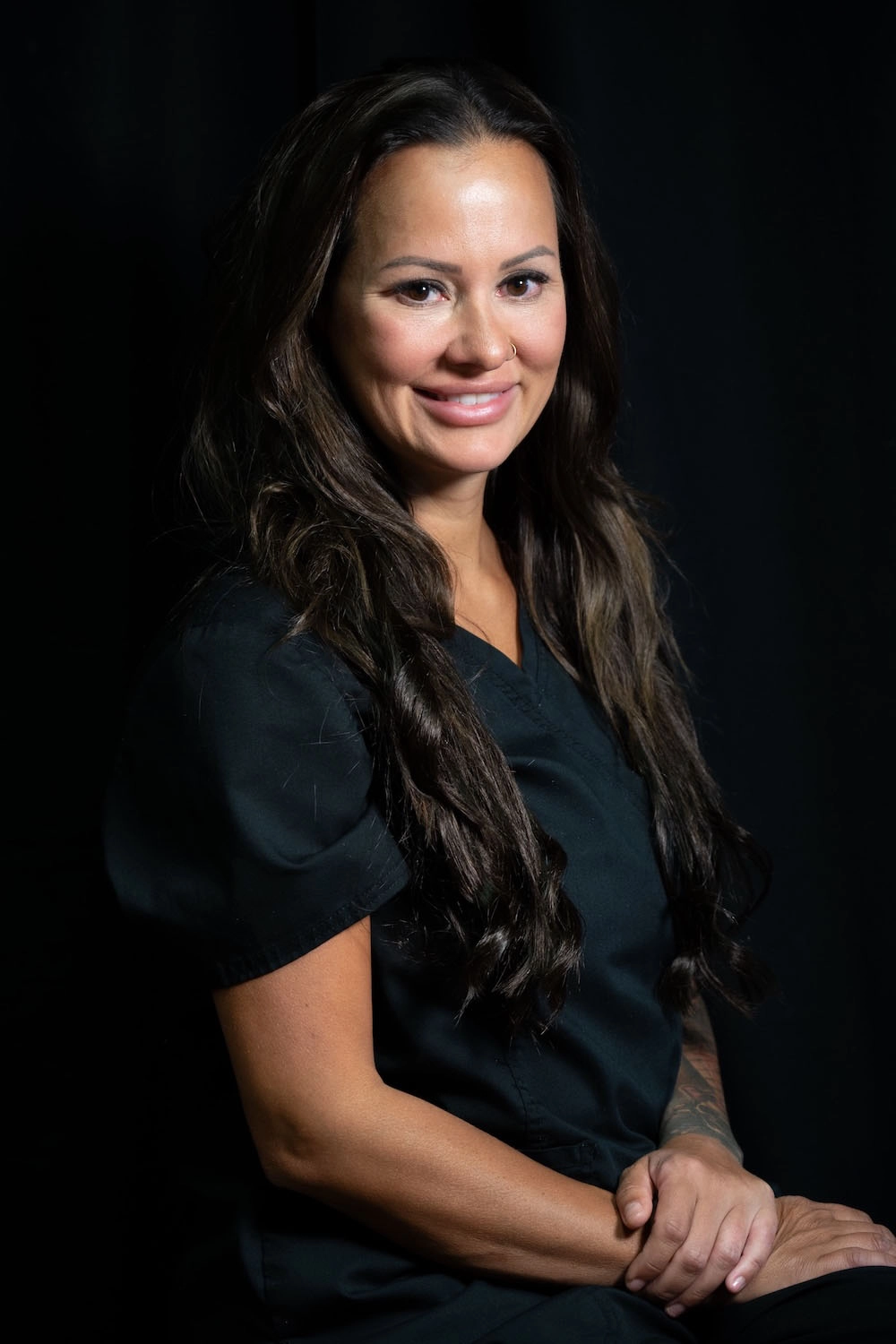 Stefanie Drozd, RN-BSN, clinical director of Express Med Spas in Frankfort, IL, photographed in formal black background headshot