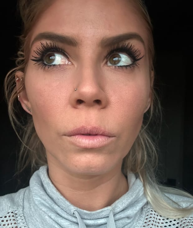 Woman anticipating the pain level of a lip filler injection at Express Medspa while undergoing the procedure.