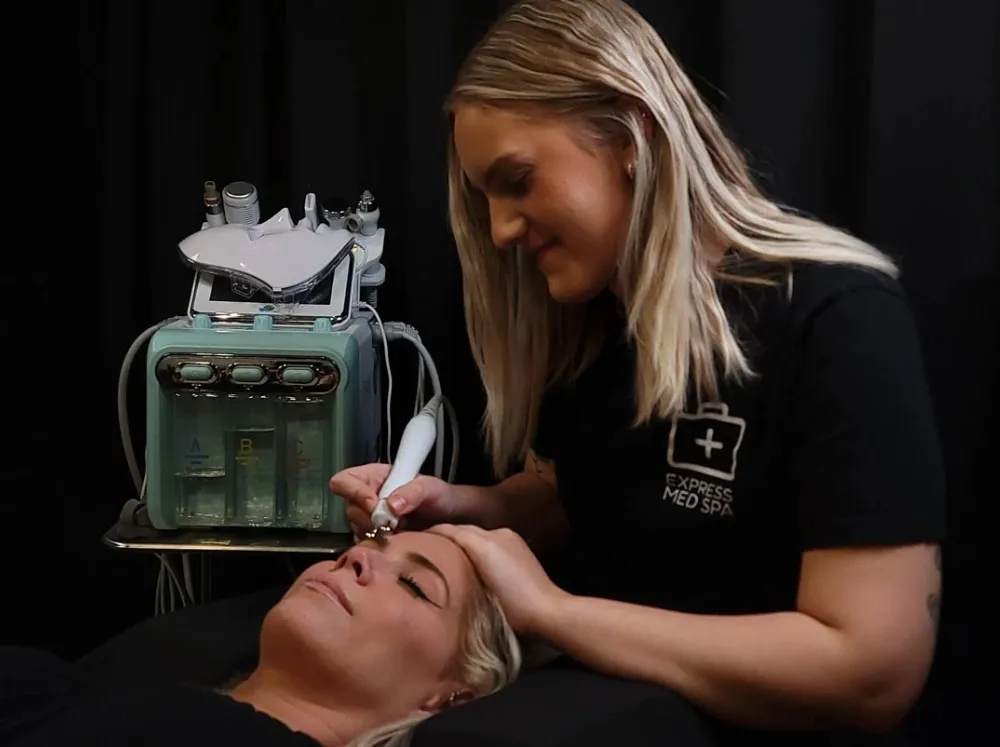 AquaFacial treatment at Express Med Spa La Grange with device gently applied to the cheek for hydration and skin renewal.