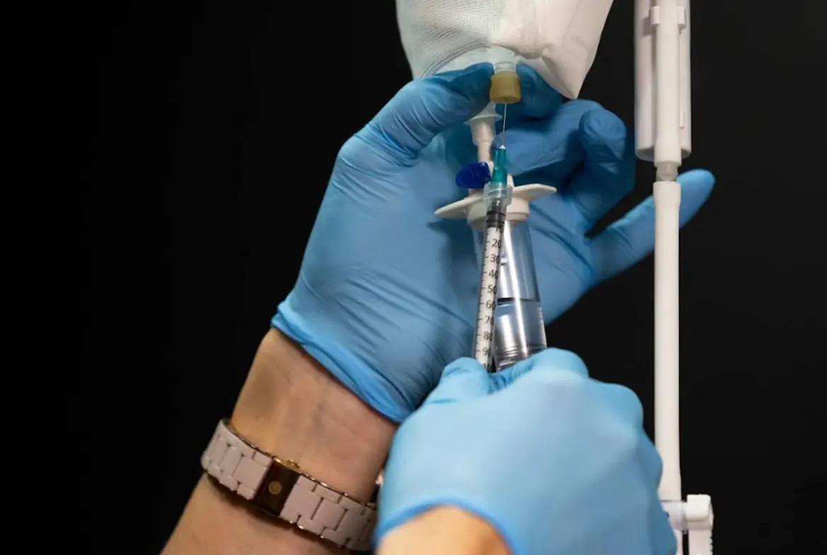 Preparing a B12 injection with syringe and IV bag at Express Med Spa La Grange, IL
