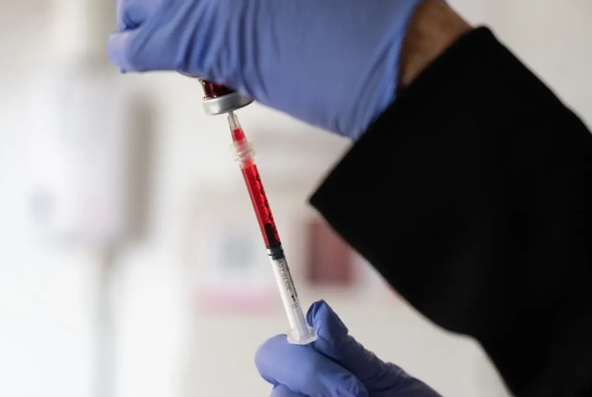 Drawing vitamin B12 into a syringe from a vial at Express Med Spa La Grange, IL