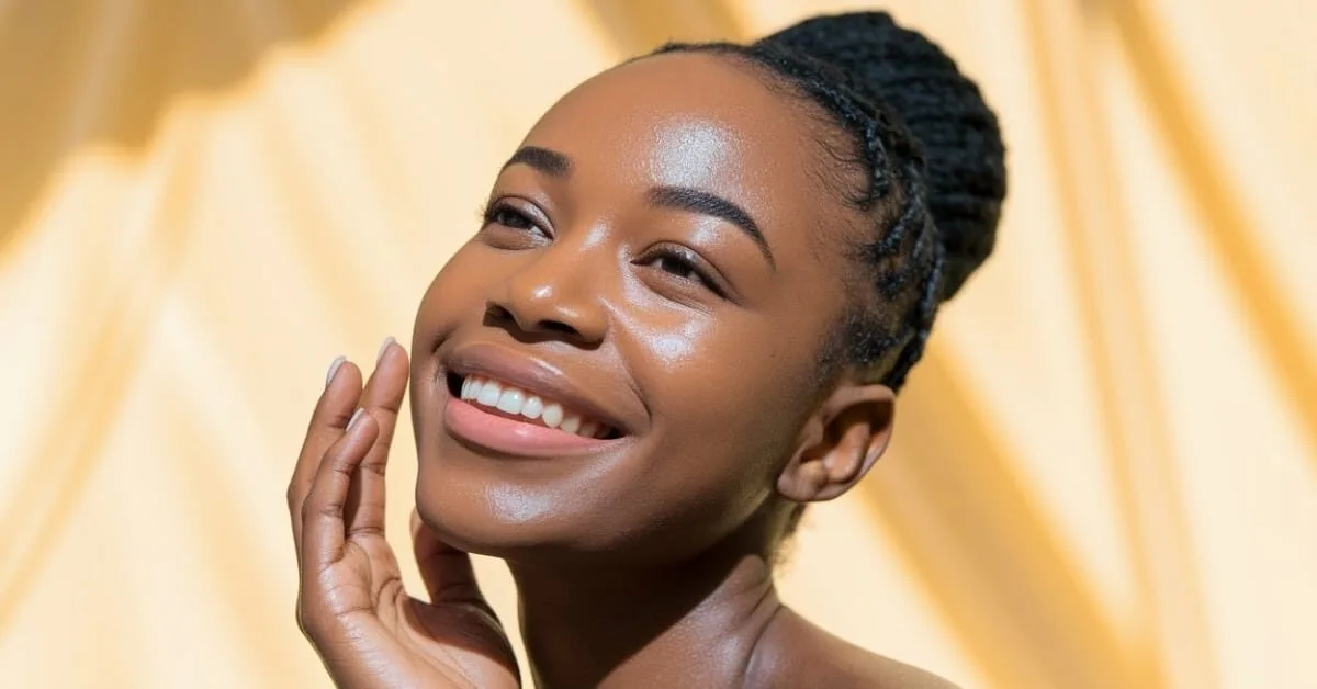 Woman with a deeper skin tone showing bright, even, glowing skin after a chemical peel at Express Med Spa