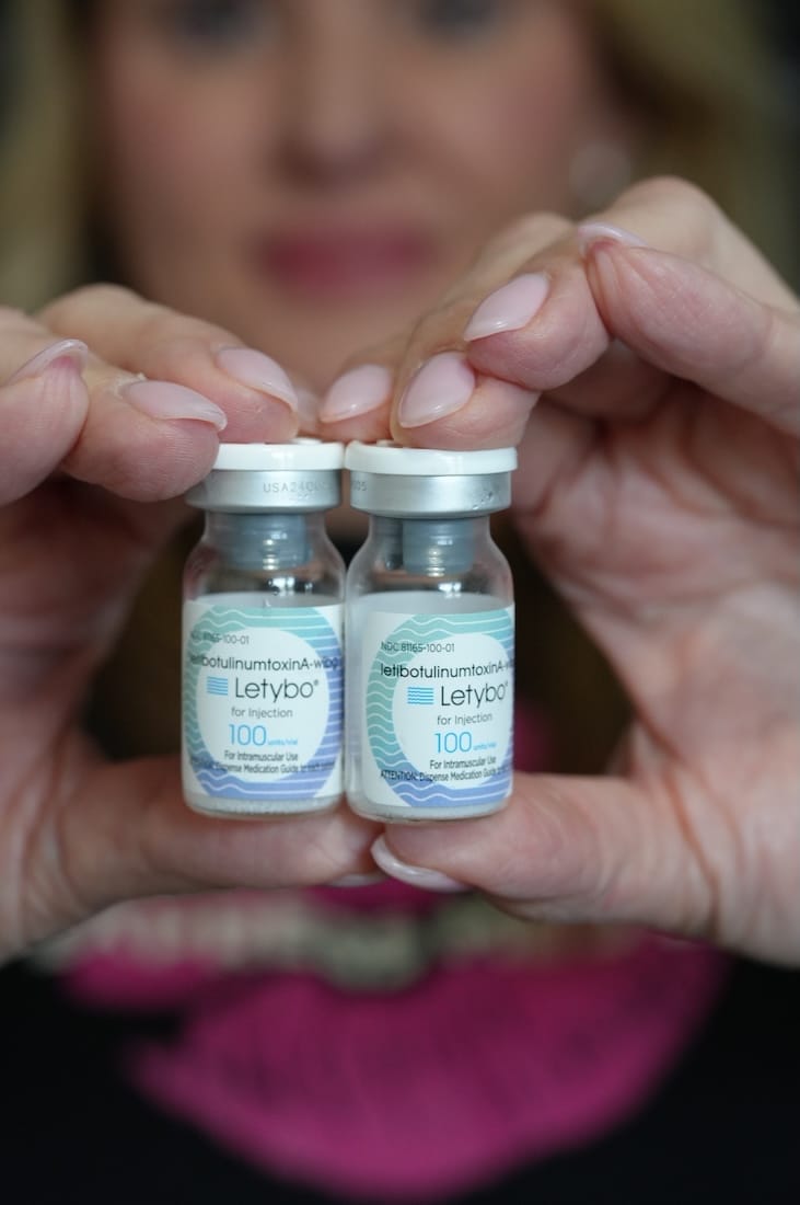 Hands holding two Letybo vials