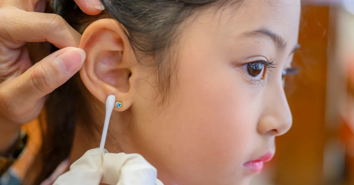 A young client receives a gentle ear piercing at Express Med Spa. Healing time is 6–8 weeks. How to clean ear piercing