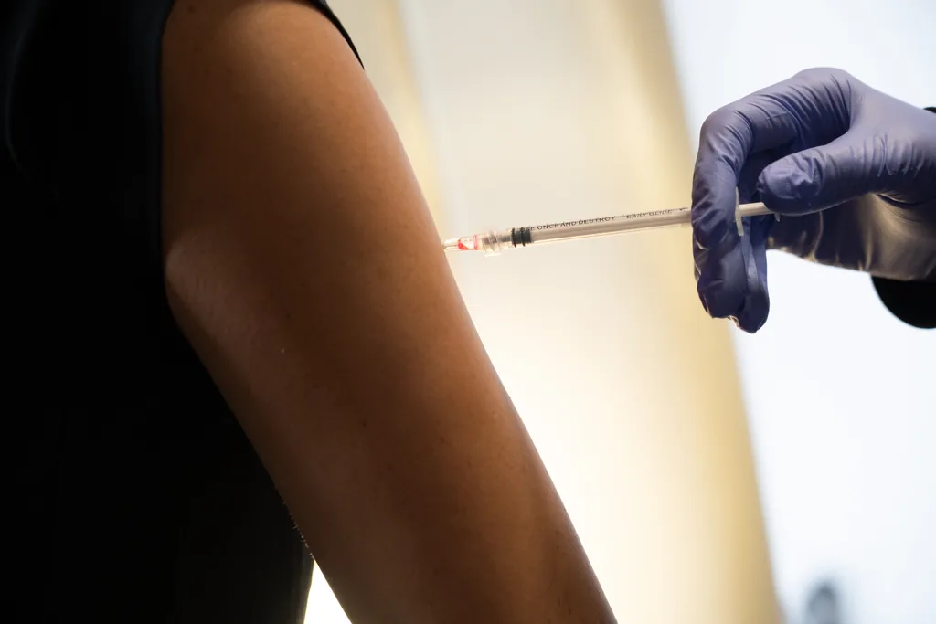 Nurse practitioner giving an intramuscular injection in the upper arm at Express Med Spa, the delivery method used for NAD+ injections