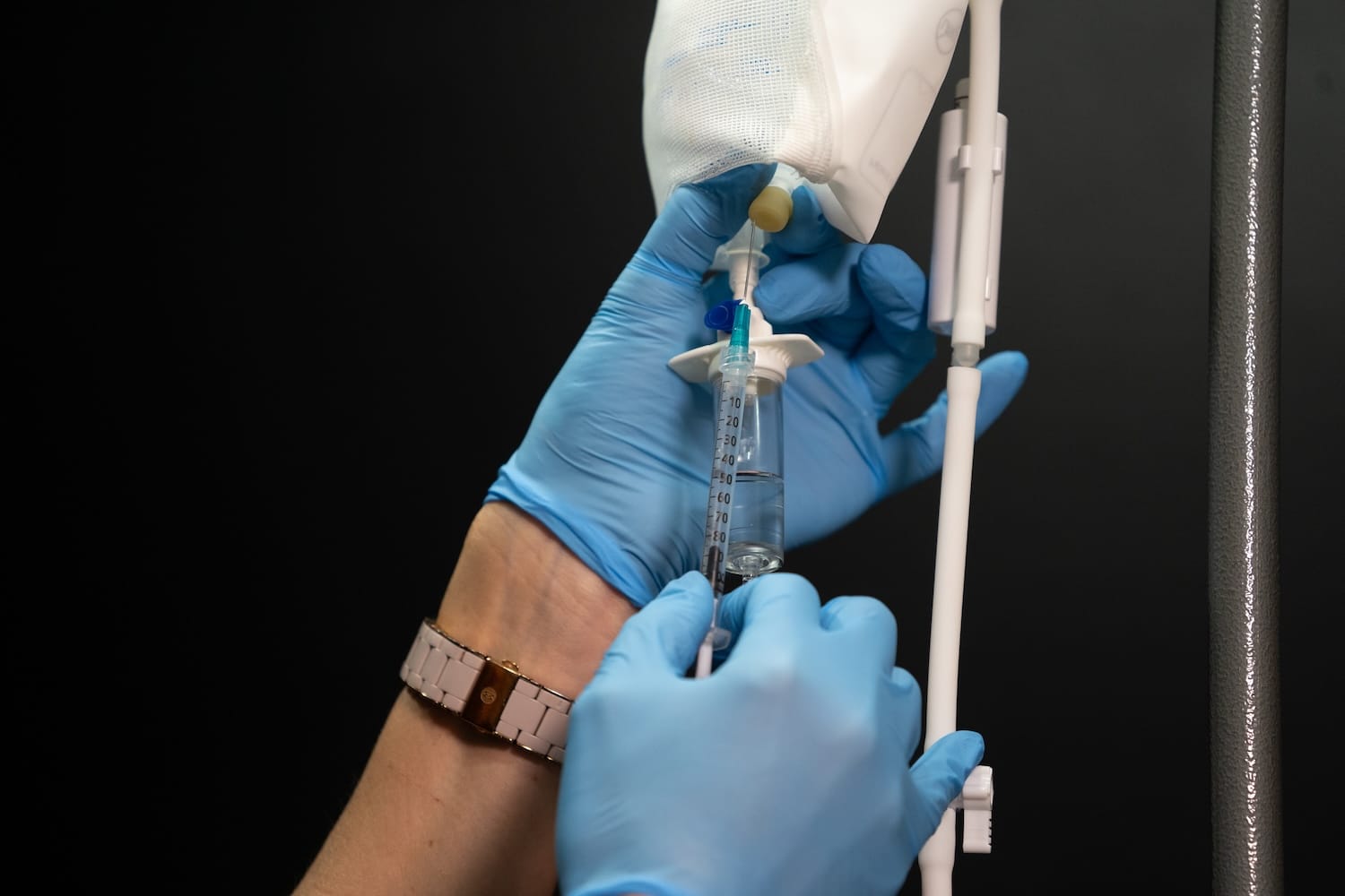 Desk with water glass, pain relief medicine, and coffee cup symbolizing fatigue and dehydration before IV therapy at Express Med Spa La Grange IL