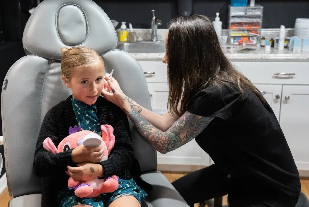 Kid-friendly ear piercing in La Grange with two clinicians ready to pierce both earlobes at the same time