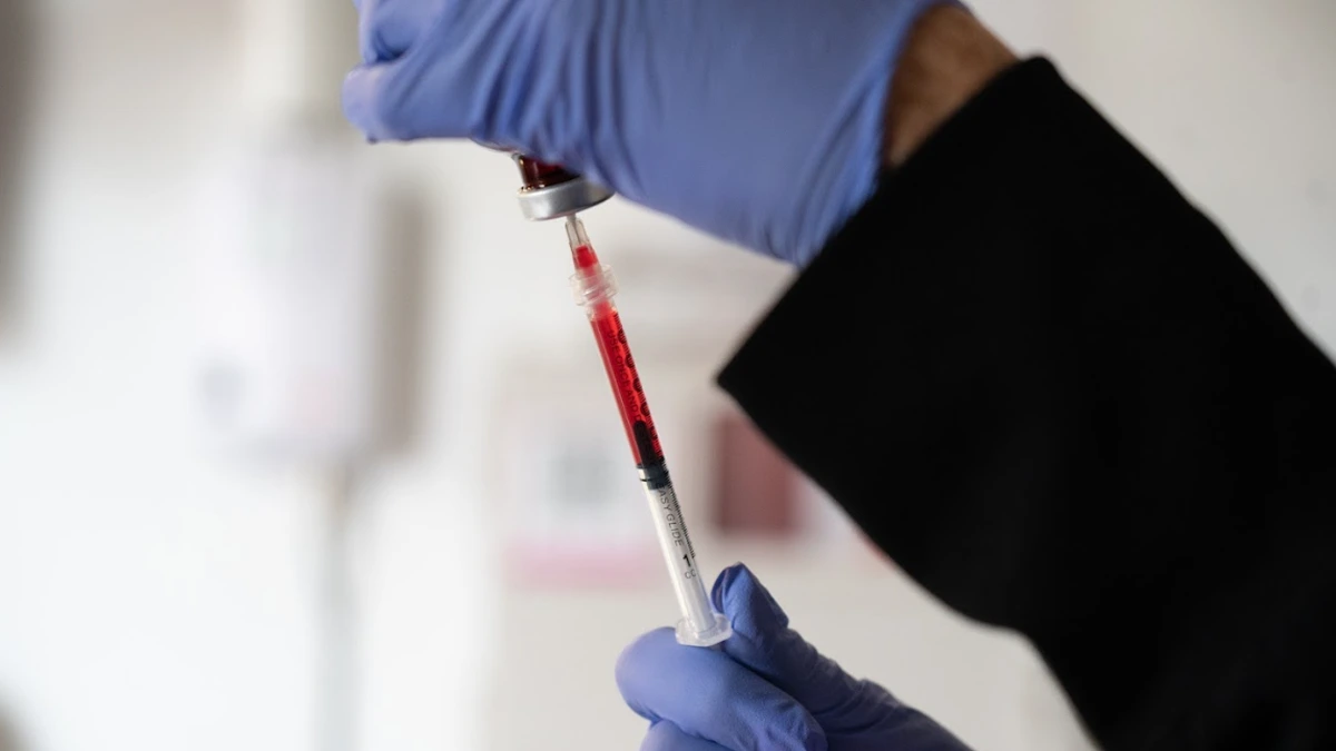 Nurse preparing Vitamin B12 injection for health and wellness services